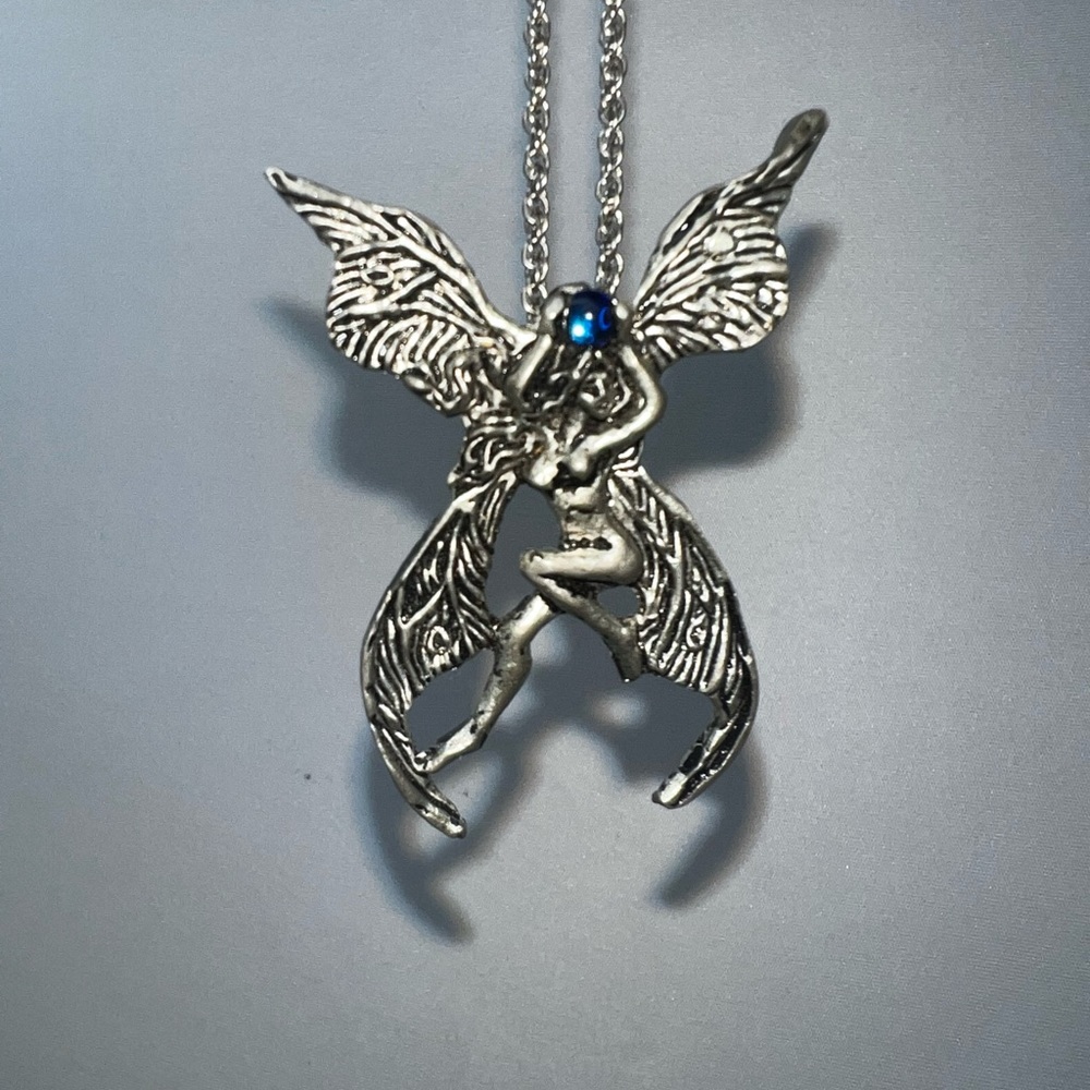 1996 fellowship foundry double winged fairy holding a blue glass ball